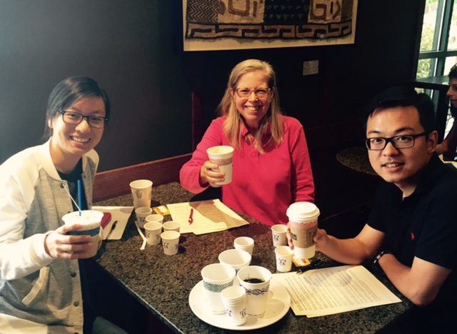 Kim at a café with two people.