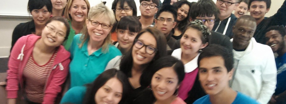 Kim smiling with a group of people.